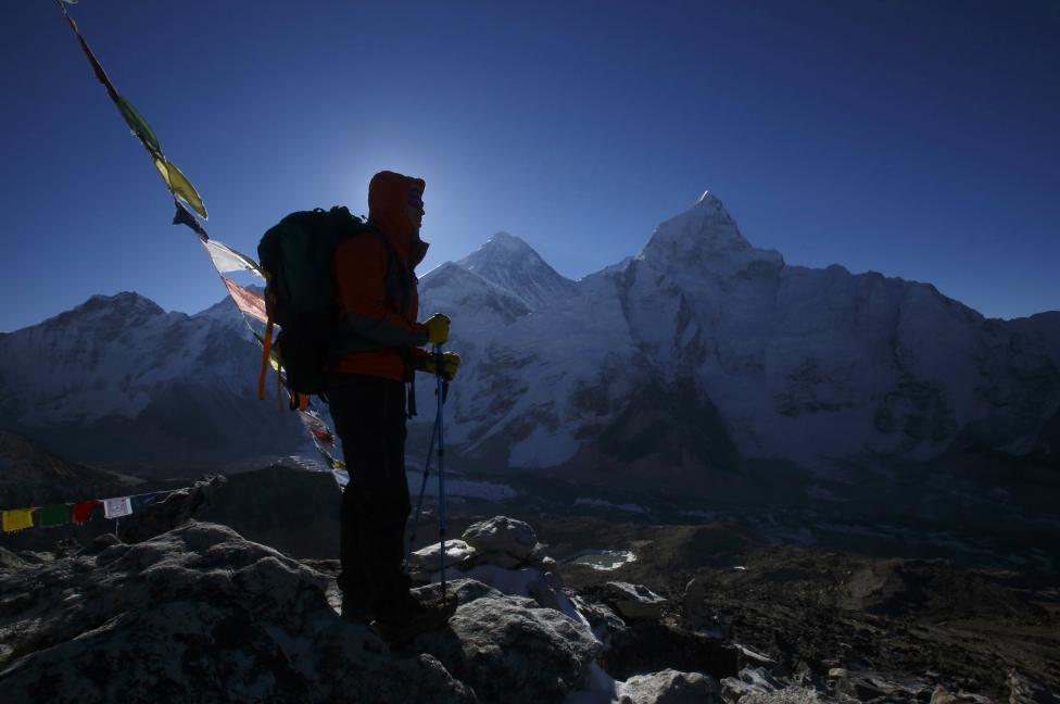 A trekker stands in front of Mount Everest at Kala Patthar in Solukhumbu District