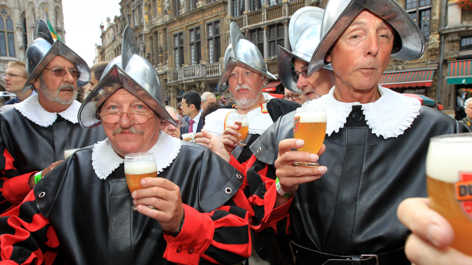 Бельгийские мужчины в костюмах и с пивом